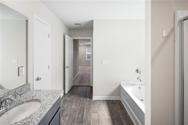 10529 Wales Ln, Spanish Fort, AL 36527 - full bath with wood finished floors, vanity, a bath, and a shower