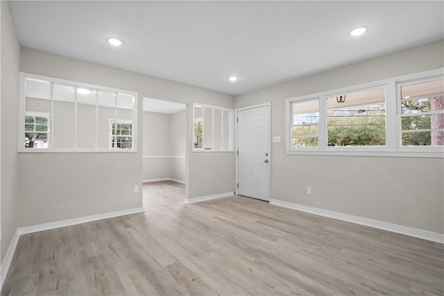 unfurnished room featuring a wealth of natural light and light wood-type flooring