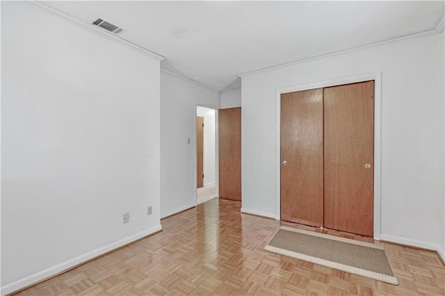 unfurnished bedroom featuring a closet, light parquet flooring, and ornamental molding