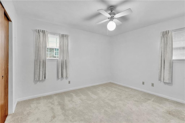 carpeted empty room featuring ceiling fan