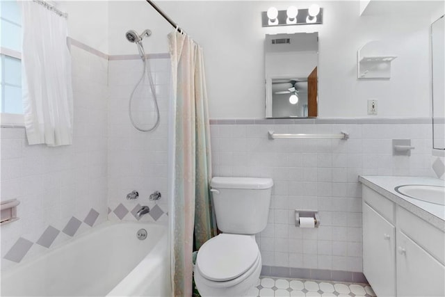 full bathroom featuring shower / bath combo with shower curtain, vanity, tile walls, and toilet