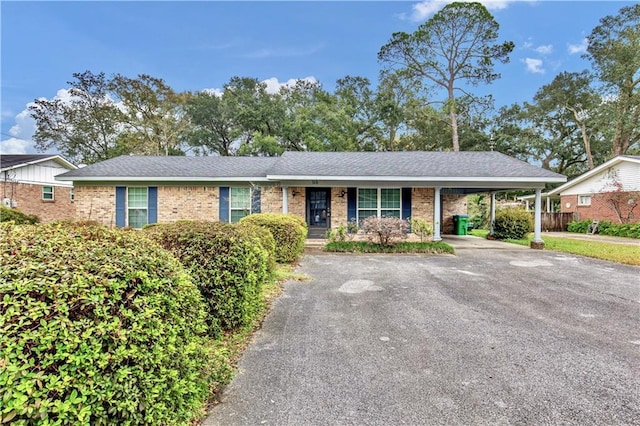 ranch-style home featuring a carport