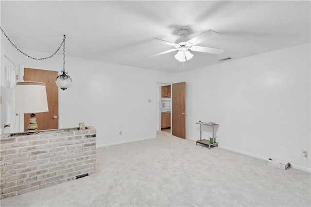 interior space featuring carpet flooring and ceiling fan