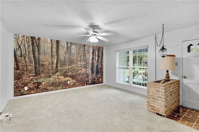 interior space featuring ceiling fan and dark carpet