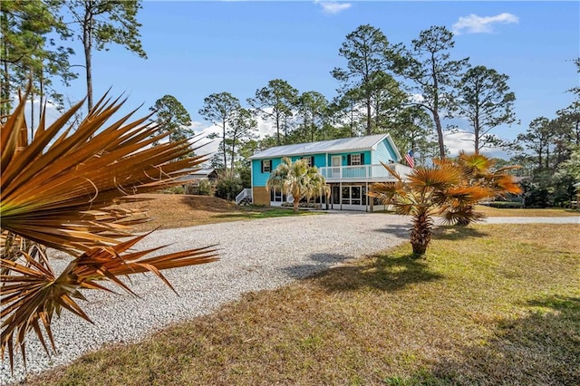 view of front of house with a front yard and a carport