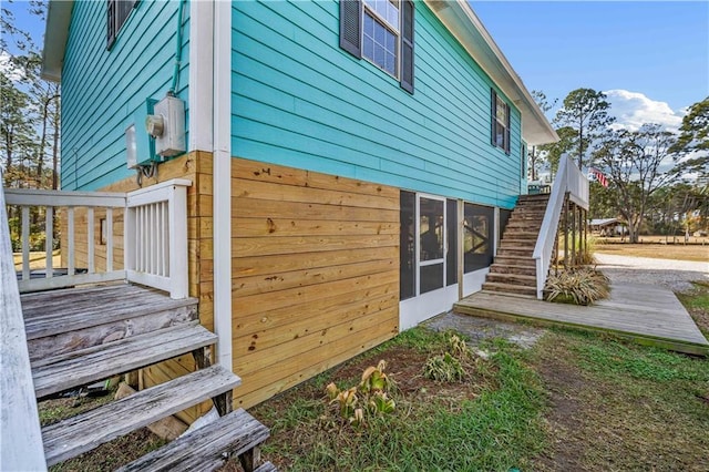 view of side of property with a sunroom