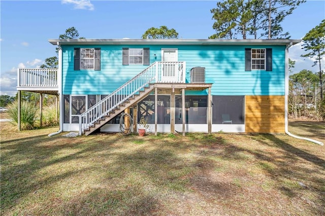 back of house featuring a sunroom and a yard