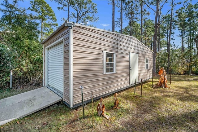 exterior space with a garage and an outdoor structure