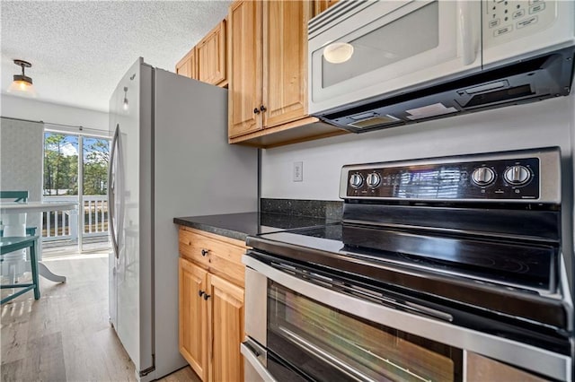 kitchen featuring stainless steel electric stove, a textured ceiling, and light hardwood / wood-style floors