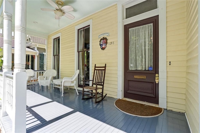 property entrance featuring covered porch and a ceiling fan