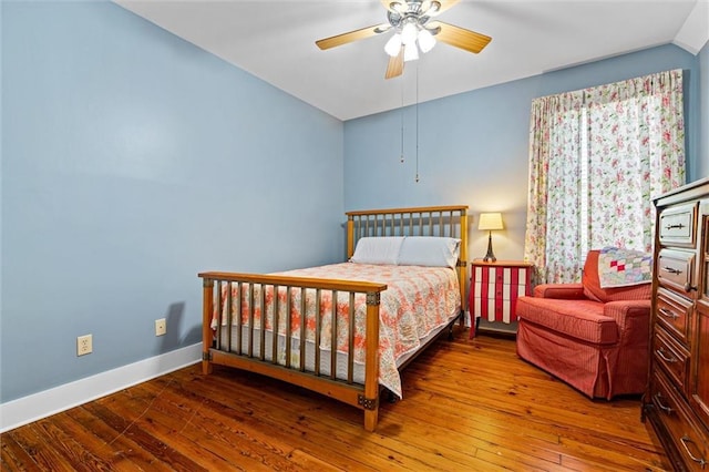 bedroom featuring hardwood / wood-style floors, ceiling fan, baseboards, and lofted ceiling
