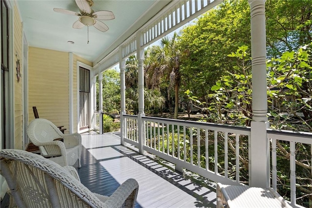 wooden deck with covered porch and ceiling fan