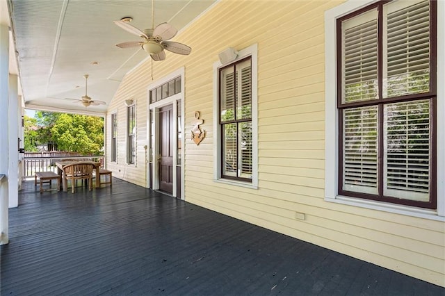 wooden terrace featuring a ceiling fan and covered porch
