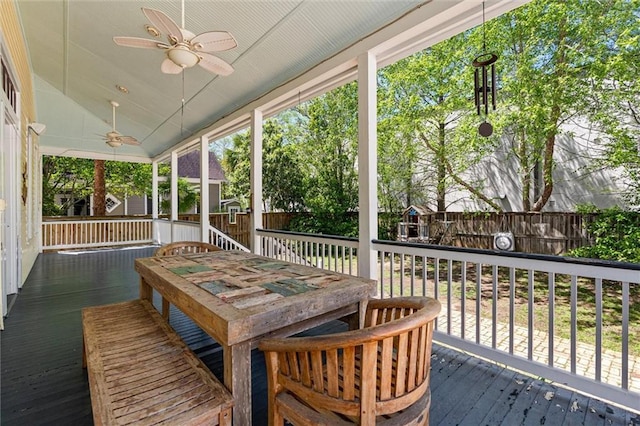 sunroom / solarium with outdoor dining space and ceiling fan