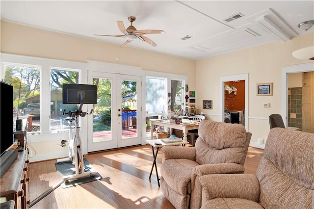 interior space featuring ceiling fan, light wood-type flooring, french doors, and a healthy amount of sunlight