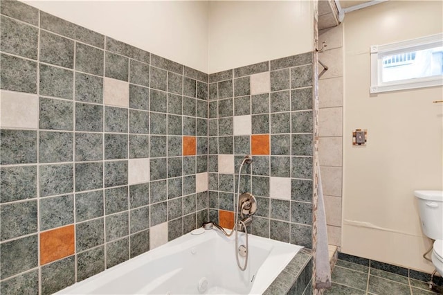 bathroom featuring toilet, tiled bath, and tile patterned floors