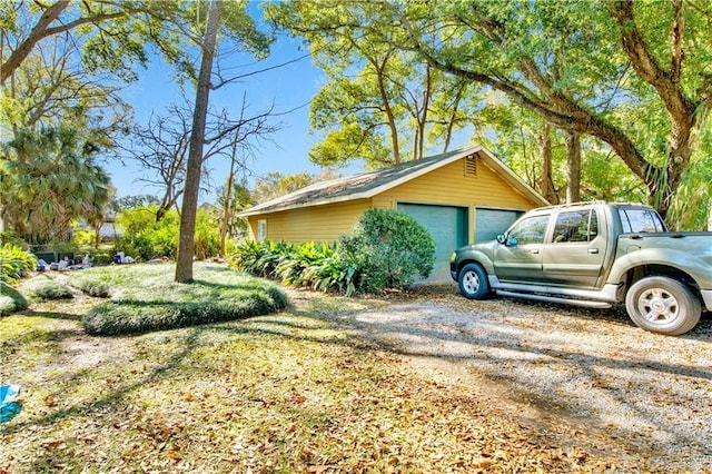 view of side of home with an outbuilding and a garage