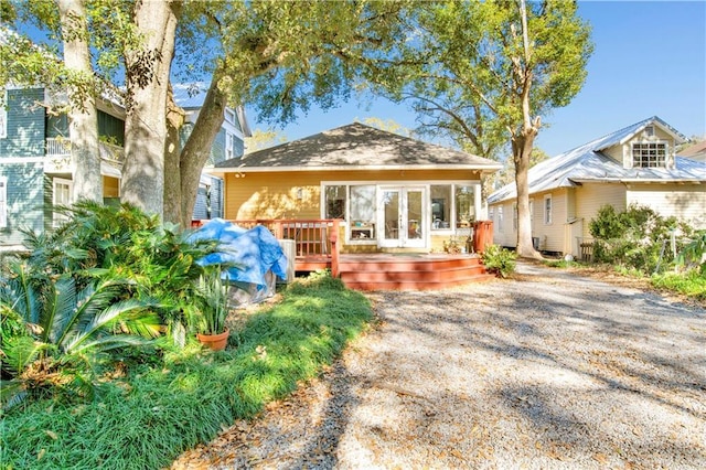 rear view of property with a wooden deck