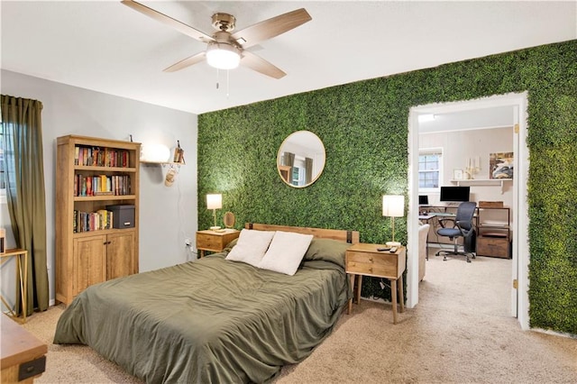 bedroom with a ceiling fan, carpet, and wallpapered walls