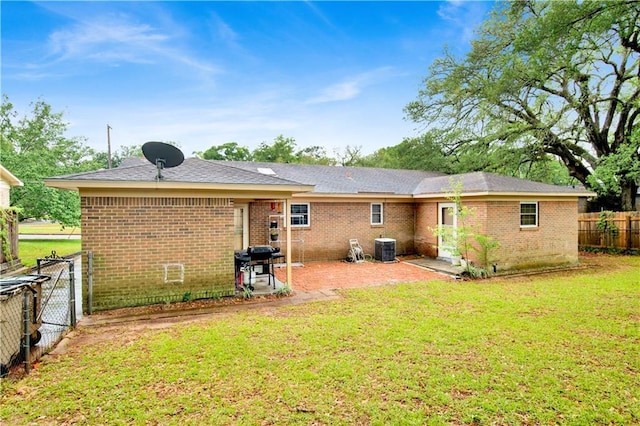 rear view of house with a yard and brick siding