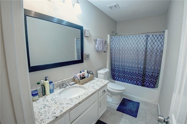 full bathroom featuring a textured ceiling, tile patterned flooring, vanity, toilet, and shower / bath combo with shower curtain