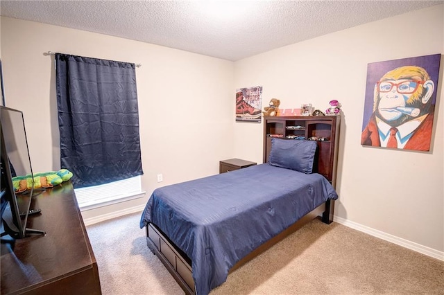 bedroom with carpet floors and a textured ceiling