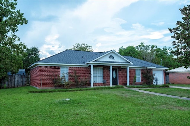 view of front of property with a garage and a front lawn