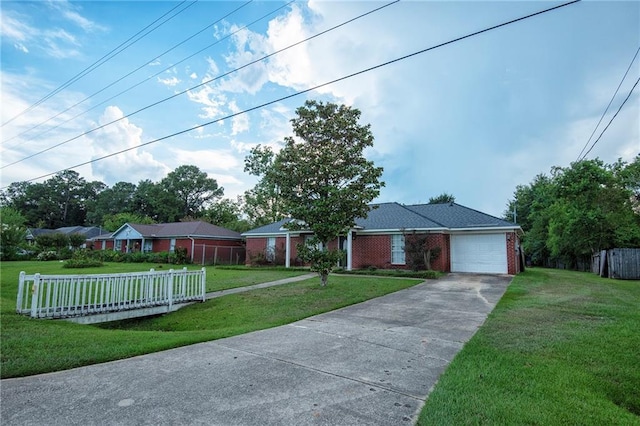 single story home featuring a front lawn and a garage