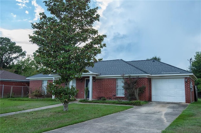 ranch-style house featuring a garage and a front yard