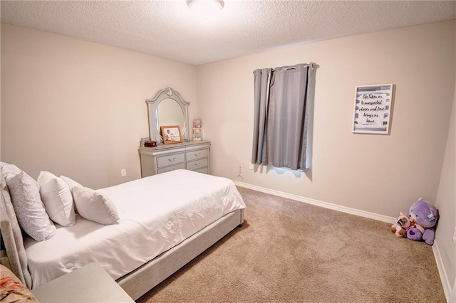 bedroom with carpet floors and a textured ceiling