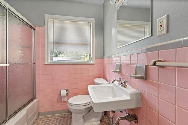 5416 Hilltop Dr N, Mobile, AL 36608 - bathroom with tile walls, combined bath / shower with glass door, wainscoting, and tile patterned flooring