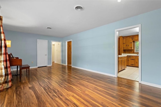 5416 Hilltop Dr N, Mobile, AL 36608 - unfurnished living room with light wood-type flooring and baseboards