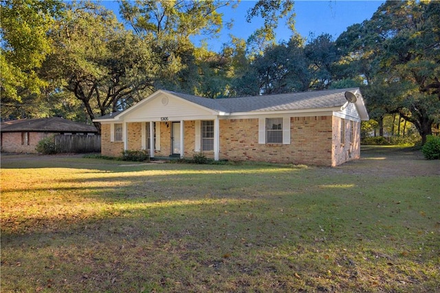 single story home with a porch and a front lawn