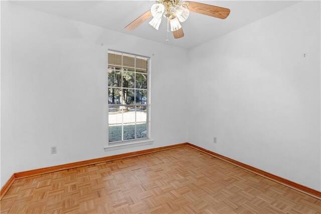 spare room featuring light parquet floors and ceiling fan