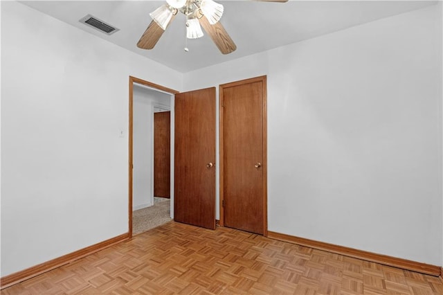 unfurnished bedroom featuring light parquet flooring and ceiling fan