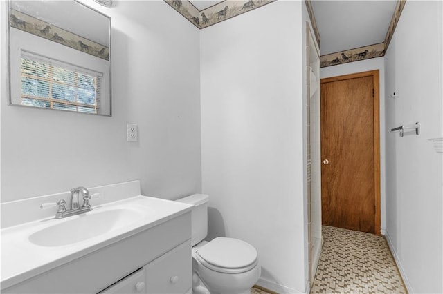 bathroom featuring walk in shower, vanity, and toilet