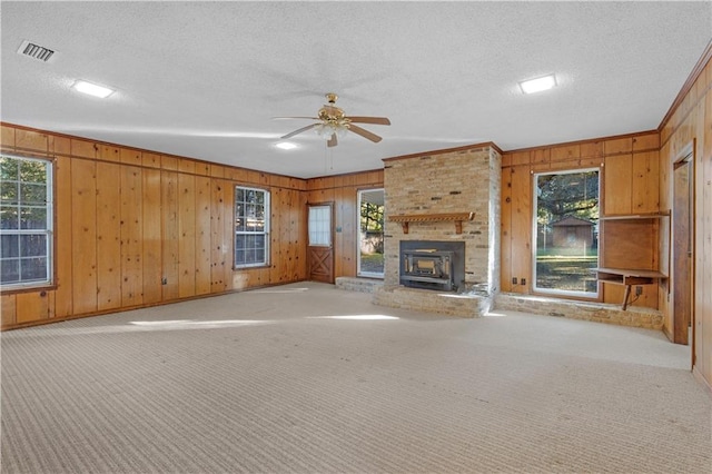 unfurnished living room featuring light colored carpet and plenty of natural light