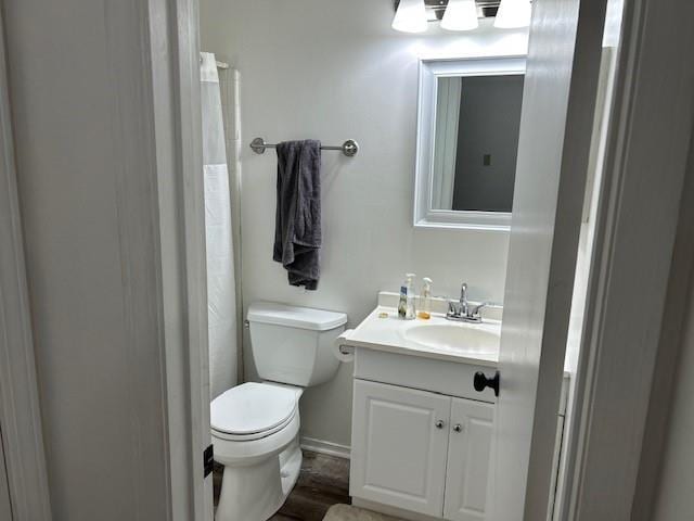 6050 Grelot Rd Unit 202, Mobile, AL 36609 - full bathroom with vanity, baseboards, toilet, and wood finished floors