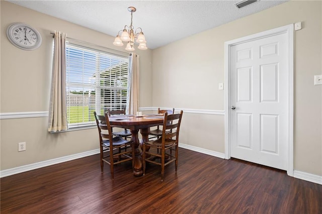 13578 James Copeland Dr, Mobile, AL 36695 - dining area with dark wood finished floors, a chandelier, baseboards, and a textured ceiling