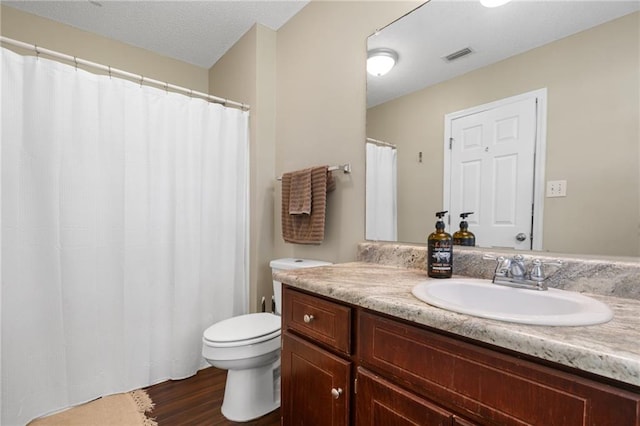 13578 James Copeland Dr, Mobile, AL 36695 - bathroom with wood finished floors, toilet, and vanity