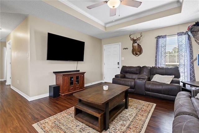 13578 James Copeland Dr, Mobile, AL 36695 - living area with a raised ceiling, dark wood-style flooring, a ceiling fan, crown molding, and baseboards
