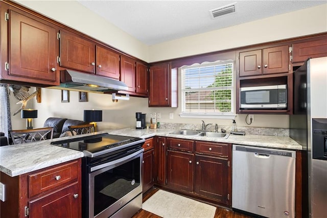 13578 James Copeland Dr, Mobile, AL 36695 - kitchen with appliances with stainless steel finishes, a sink, under cabinet range hood, and light countertops