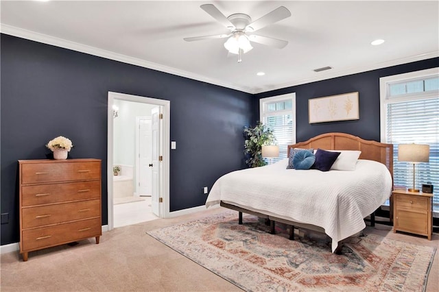 bedroom with multiple windows, ceiling fan, ensuite bath, and light colored carpet