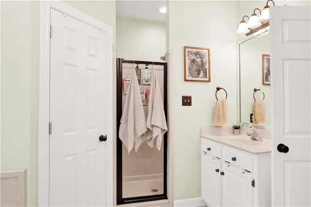 bathroom featuring vanity and a shower with shower door