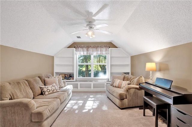 carpeted living room featuring ceiling fan, lofted ceiling, and a textured ceiling