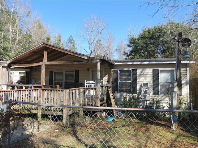 view of front of house featuring fence and a deck