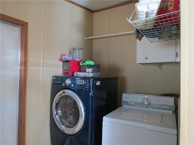 washroom featuring cabinet space and independent washer and dryer