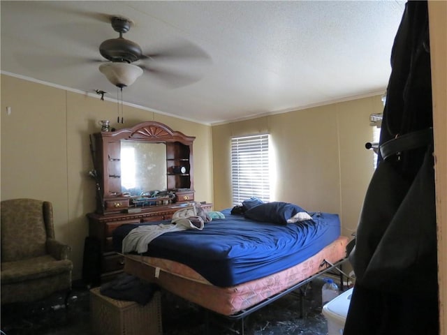 bedroom with ornamental molding and a ceiling fan