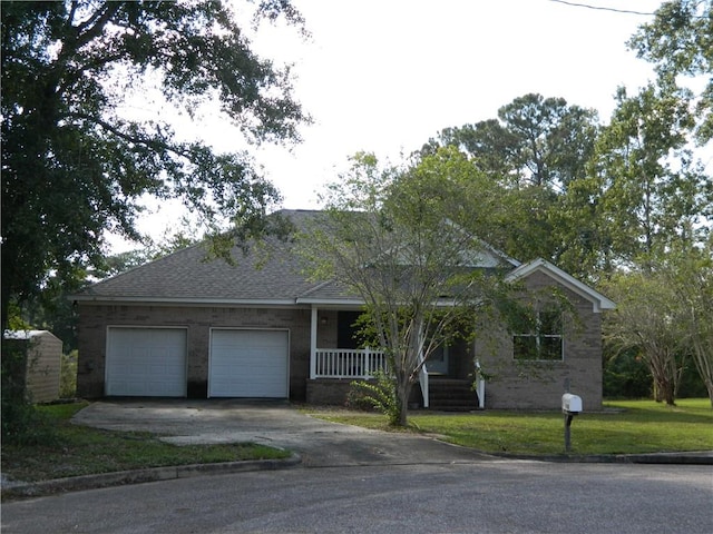 ranch-style home with a garage, a front lawn, and covered porch