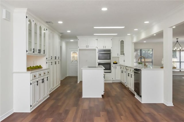 kitchen featuring kitchen peninsula, double oven, sink, white cabinets, and dark hardwood / wood-style floors